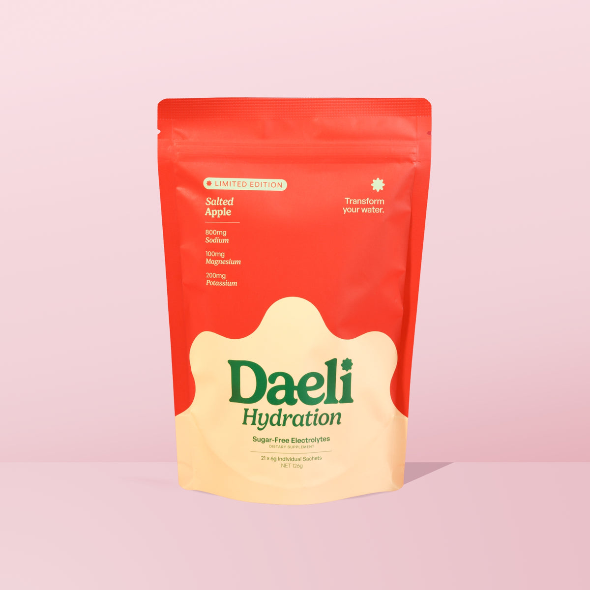 Daeli Hydration Salted Apple electrolyte powder pouch on a pink background - sugar-free hydration with essential electrolytes.
