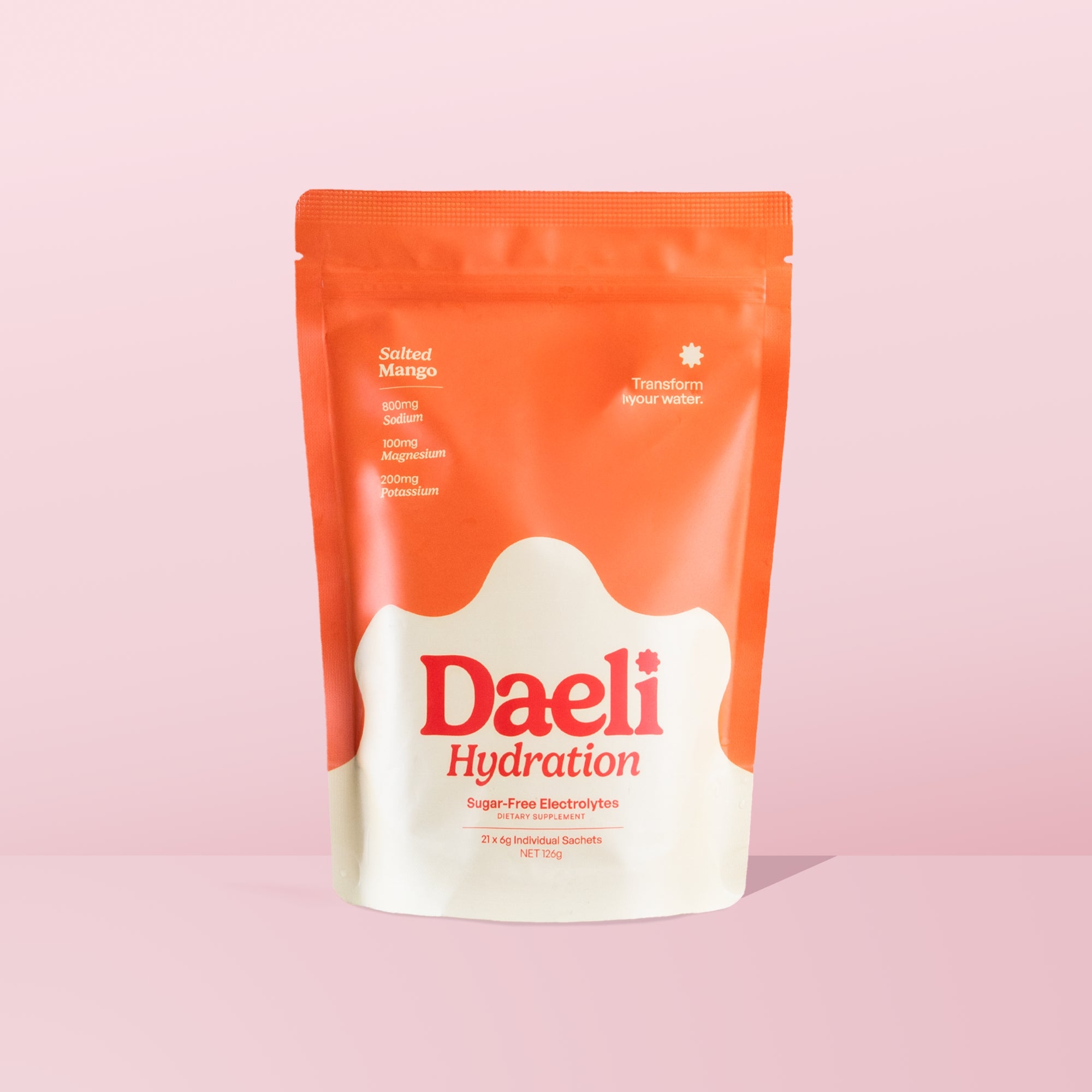 Daeli Hydration Salted Mango electrolyte powder pouch on a pink background - sugar-free hydration with essential electrolytes.