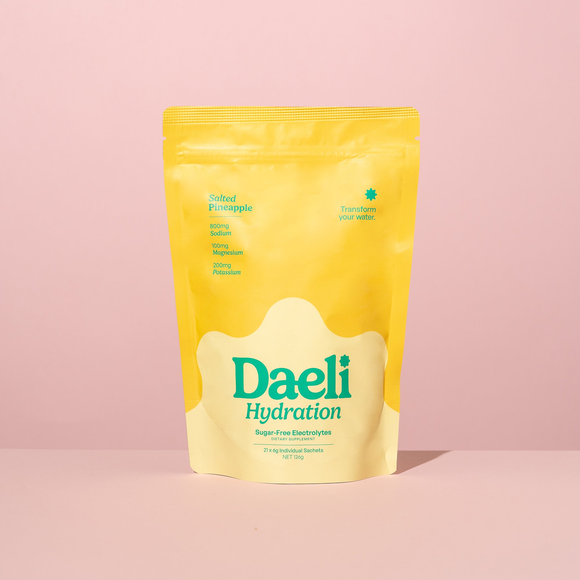 Daeli Hydration Salted Pineapple electrolyte powder pouch on a pink background - sugar-free hydration with essential electrolytes.